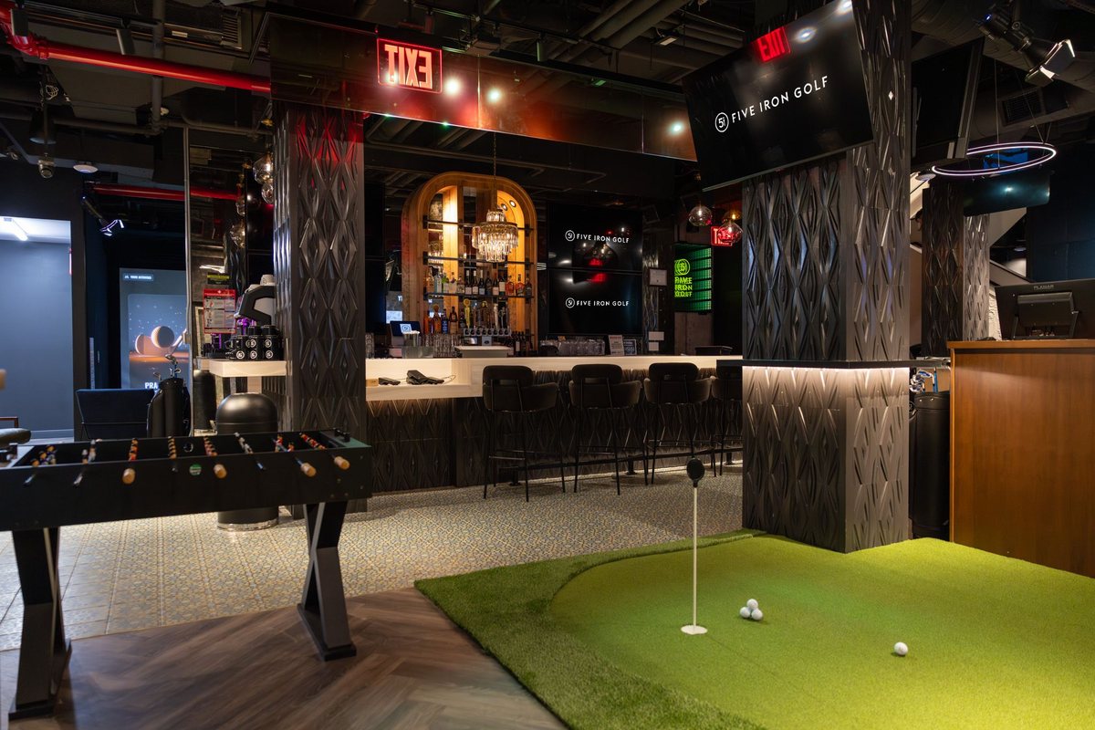 CORCON tenant improvement buildout for Five Iron Golf's Flatiron flagship in New York City — full-service bar and indoor putting green