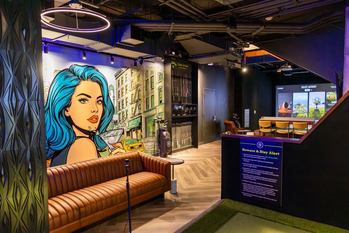 CORCON tenant improvement buildout for Five Iron Golf's Flatiron flagship in New York City — simulator bay lounge with commissioned mural wall and Callaway Tour Fitting studio